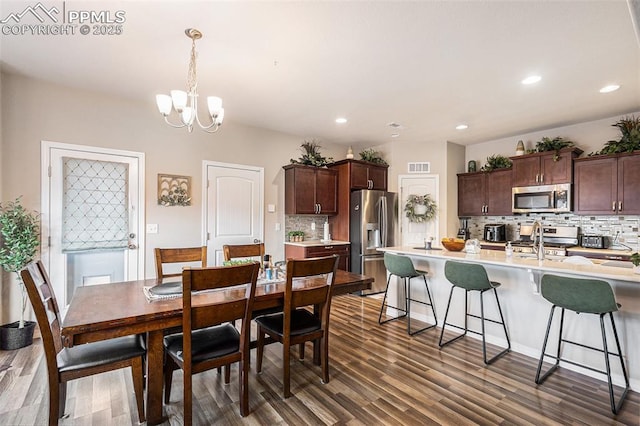 dining room featuring a chandelier, recessed lighting, visible vents, and dark wood-style flooring