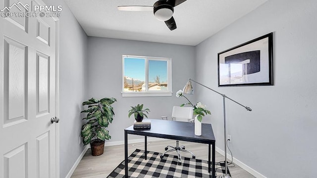 office area with baseboards, wood finished floors, and ceiling fan