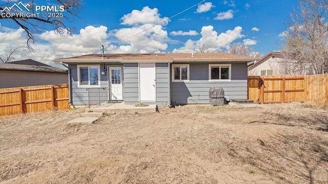 back of property featuring fence