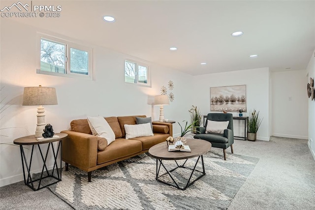 living area featuring baseboards, recessed lighting, and light colored carpet