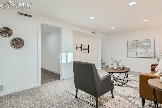 carpeted living room featuring stairs, visible vents, baseboards, and recessed lighting