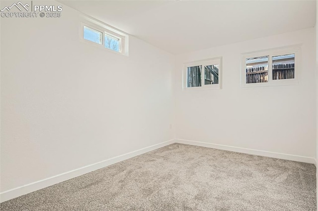 carpeted spare room with baseboards
