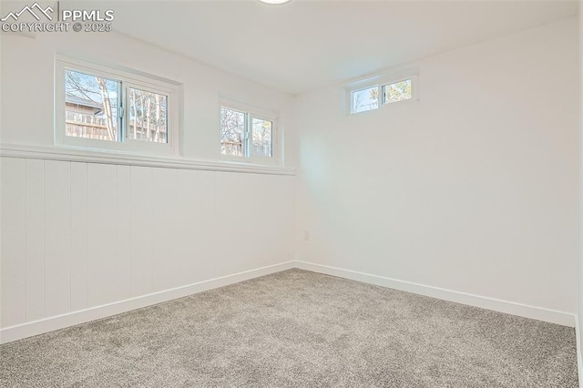 unfurnished room featuring baseboards and carpet