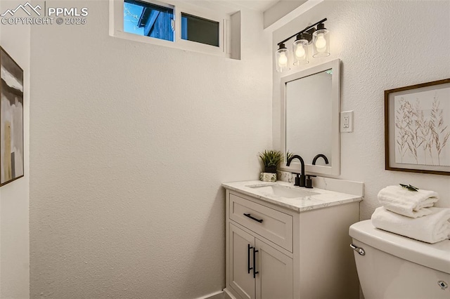 half bath featuring toilet and vanity