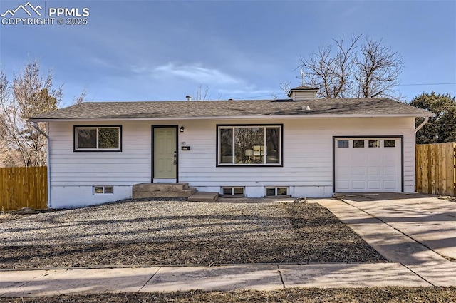 ranch-style house with driveway, a garage, and fence