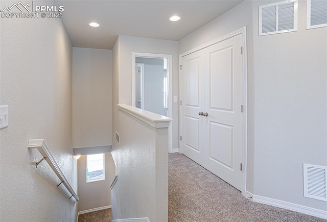 7372 Cornice Pt, Colorado Springs, CO 80923 - hallway featuring an upstairs landing, visible vents, and carpet