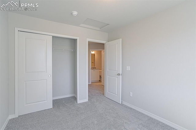 7372 Cornice Pt, Colorado Springs, CO 80923 - unfurnished bedroom featuring a closet, light carpet, baseboards, and attic access