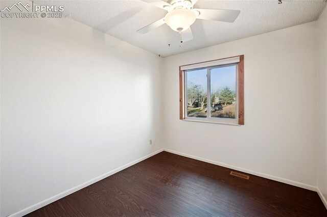 6745 Fielding Cir, Colorado Springs, CO 80911 - spare room with dark wood-type flooring, baseboards, a textured ceiling, and visible vents