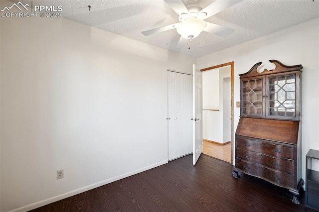 6745 Fielding Cir, Colorado Springs, CO 80911 - unfurnished bedroom with a closet, a textured ceiling, baseboards, ceiling fan, and wood finished floors