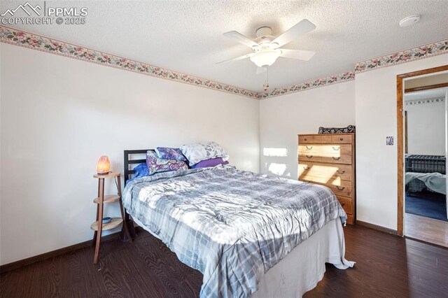 6745 Fielding Cir, Colorado Springs, CO 80911 - bedroom with baseboards, a textured ceiling, and wood finished floors