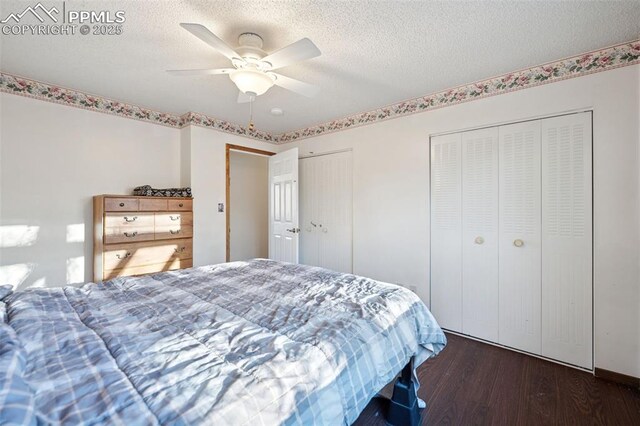 6745 Fielding Cir, Colorado Springs, CO 80911 - bedroom featuring two closets, a ceiling fan, a textured ceiling, and wood finished floors