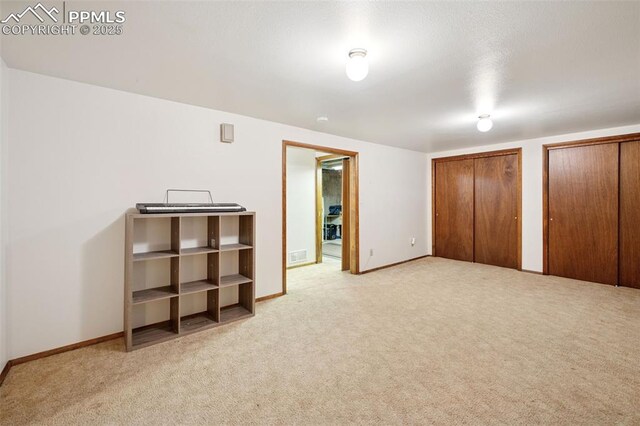 6745 Fielding Cir, Colorado Springs, CO 80911 - unfurnished bedroom featuring baseboards, multiple closets, visible vents, and carpet