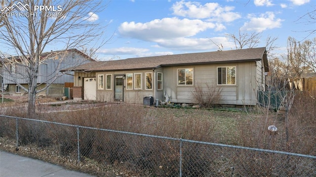 6745 Fielding Cir, Colorado Springs, CO 80911 - view of front of property with driveway, a shingled roof, fence, and an attached garage