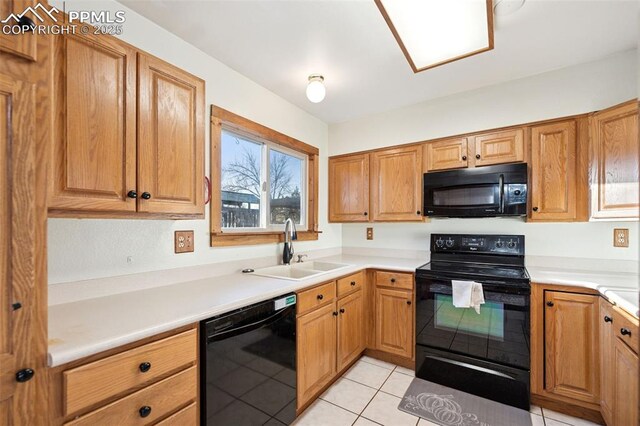 6745 Fielding Cir, Colorado Springs, CO 80911 - kitchen with light countertops, light tile patterned floors, a sink, black appliances, and brown cabinets