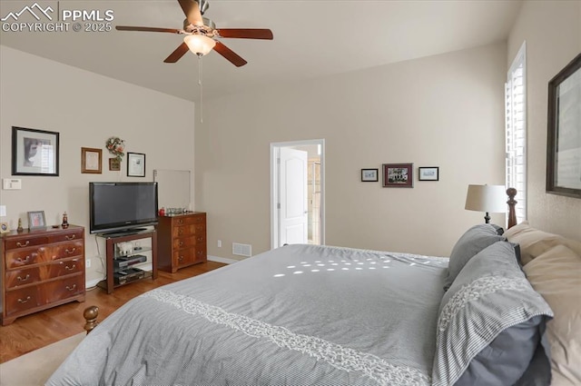 bedroom with visible vents, wood finished floors, and ceiling fan