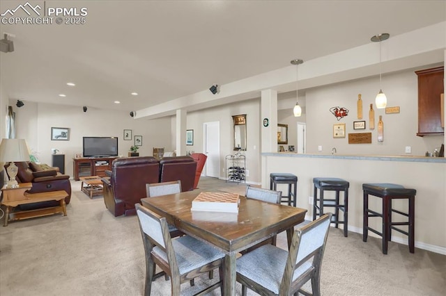 dining space featuring light colored carpet, baseboards, and recessed lighting
