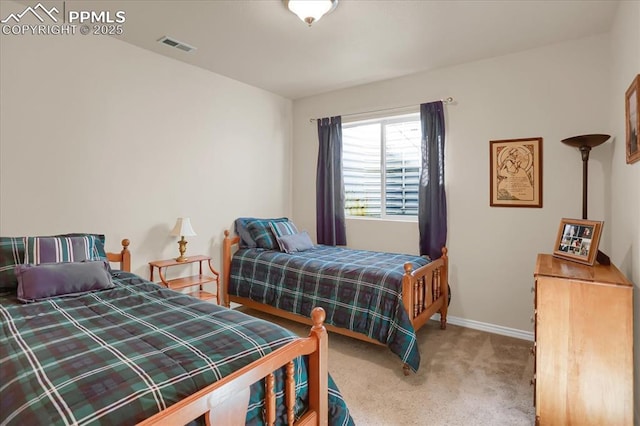carpeted bedroom with baseboards and visible vents