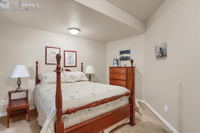 bedroom featuring baseboards and light colored carpet