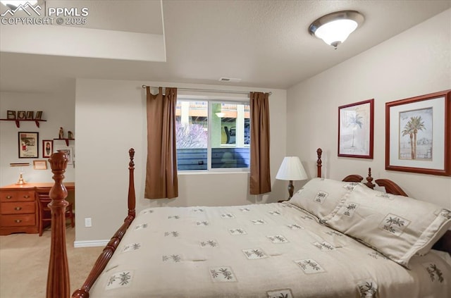 bedroom featuring visible vents and light carpet