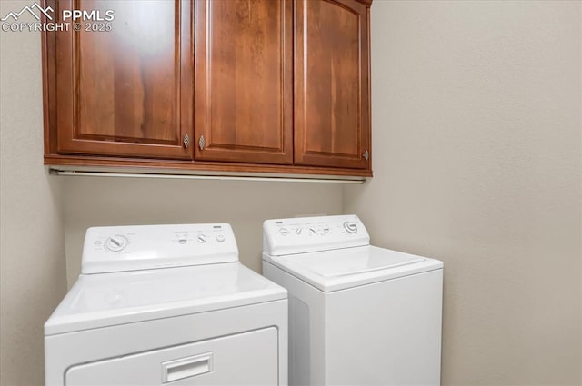 laundry area featuring washing machine and dryer and cabinet space