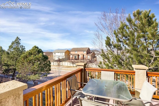 deck with a residential view, outdoor dining area, and area for grilling