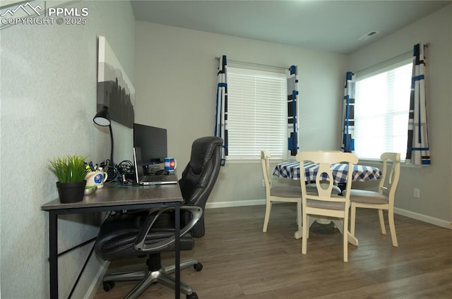 office space with visible vents, baseboards, and wood finished floors