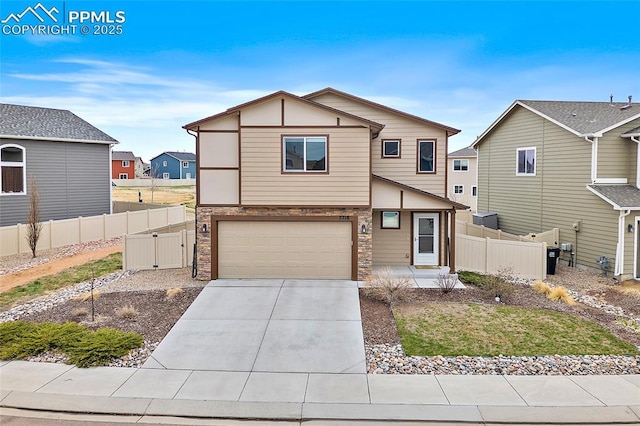 7718 Benecia Dr, Fountain, CO 80817 - view of front of house with an attached garage, driveway, stone siding, and fence