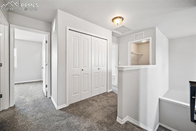 7718 Benecia Dr, Fountain, CO 80817 - hallway with dark carpet, baseboards, and visible vents