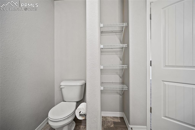 7718 Benecia Dr, Fountain, CO 80817 - bathroom with a textured wall, toilet, and baseboards