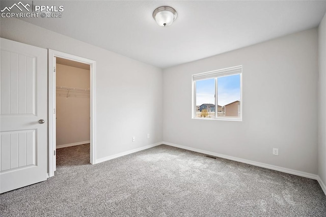 7718 Benecia Dr, Fountain, CO 80817 - unfurnished bedroom featuring visible vents, baseboards, a closet, a spacious closet, and carpet flooring
