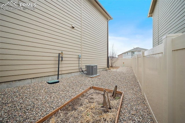 7718 Benecia Dr, Fountain, CO 80817 - view of home's exterior featuring central air condition unit, a fenced backyard, and a vegetable garden