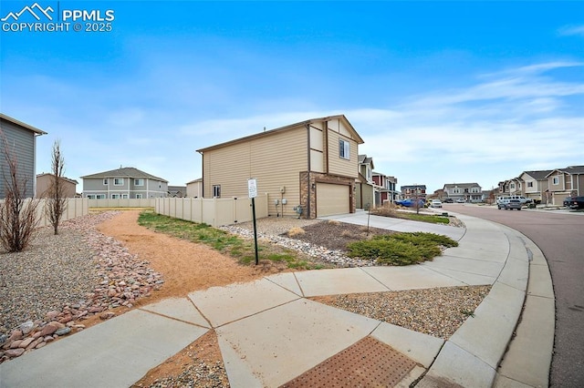 7718 Benecia Dr, Fountain, CO 80817 - view of property exterior with fence, a garage, a residential view, and driveway