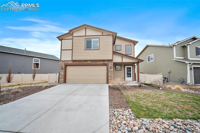 7718 Benecia Dr, Fountain, CO 80817 - view of front of home with concrete driveway, stone siding, fence, and an attached garage
