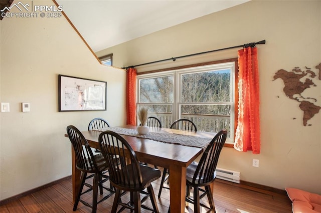 dining room with baseboards, a baseboard heating unit, and hardwood / wood-style floors