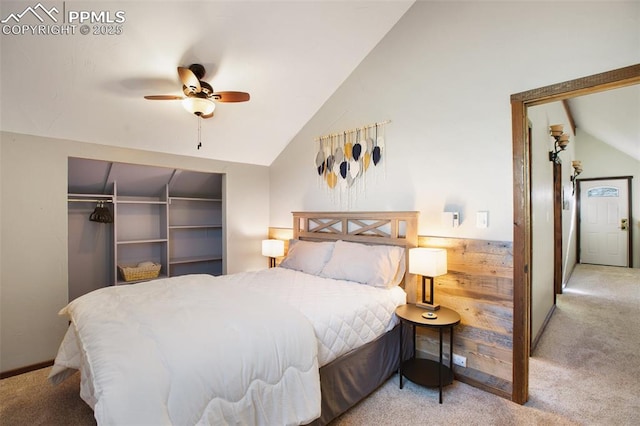 carpeted bedroom with a ceiling fan, vaulted ceiling, and a closet