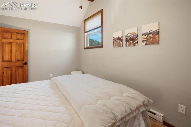 bedroom with lofted ceiling and baseboard heating