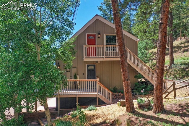 exterior space with a wooden deck and stairway