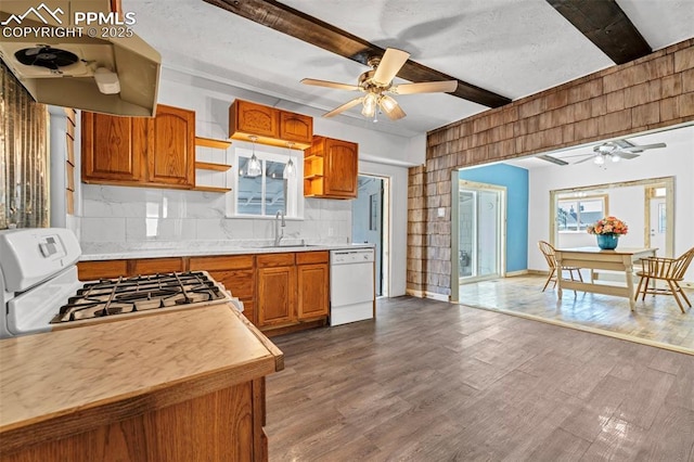 kitchen with a ceiling fan, a sink, white appliances, light countertops, and beam ceiling