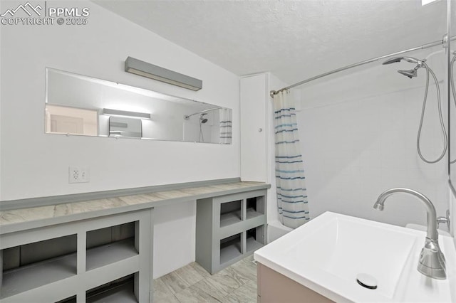 bathroom with vanity, a textured ceiling, and shower / bathtub combination with curtain