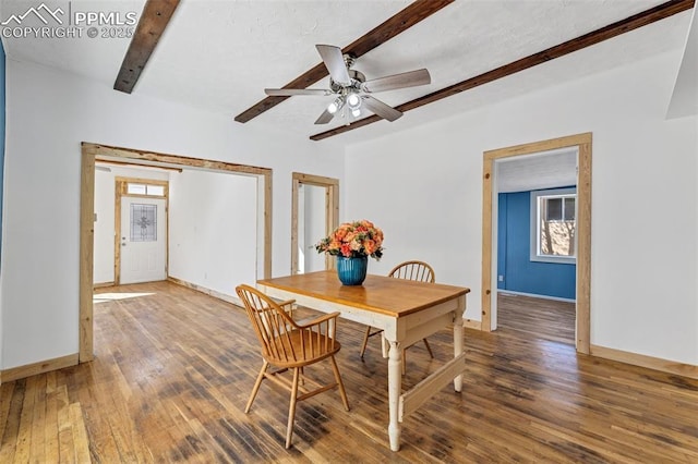 dining area with baseboards, a ceiling fan, wood finished floors, and beam ceiling