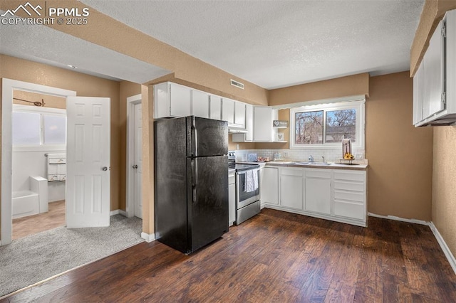 224 W Mill St, Colorado Springs, CO 80903 - kitchen with freestanding refrigerator, visible vents, dark wood-type flooring, and stainless steel electric stove