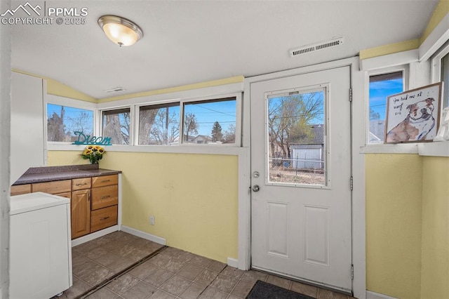 224 W Mill St, Colorado Springs, CO 80903 - doorway to outside featuring baseboards, visible vents, vaulted ceiling, and washer / dryer