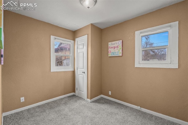 224 W Mill St, Colorado Springs, CO 80903 - unfurnished bedroom with baseboards, a textured wall, and carpet flooring