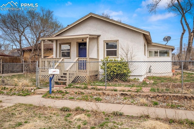 224 W Mill St, Colorado Springs, CO 80903 - view of front of home featuring covered porch, fence private yard, a gate, and stucco siding