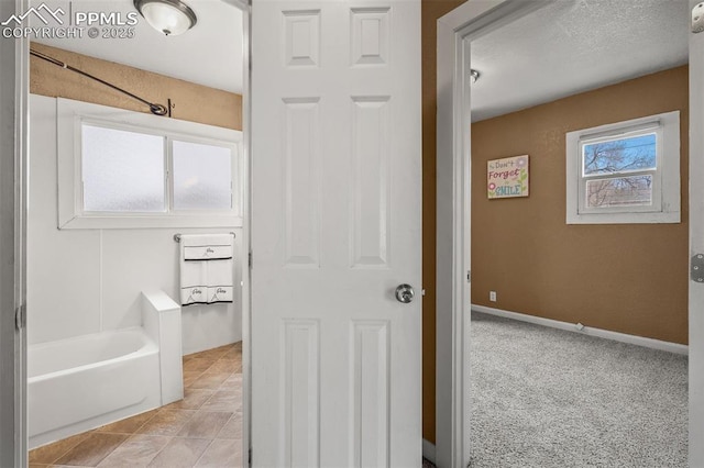224 W Mill St, Colorado Springs, CO 80903 - bathroom with baseboards, a tub, and tile patterned floors