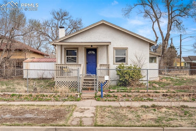 224 W Mill St, Colorado Springs, CO 80903 - bungalow-style house featuring a chimney, stucco siding, a porch, and fence private yard