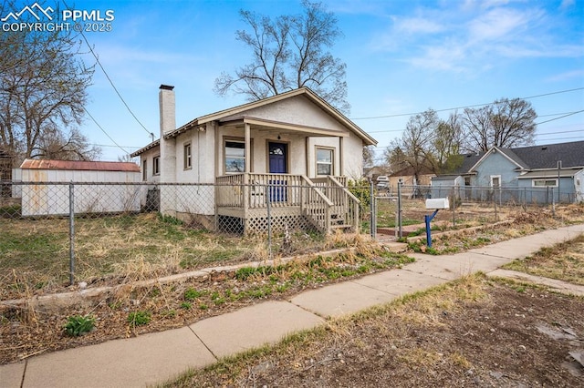 224 W Mill St, Colorado Springs, CO 80903 - bungalow-style house with a porch, a fenced front yard, and a chimney