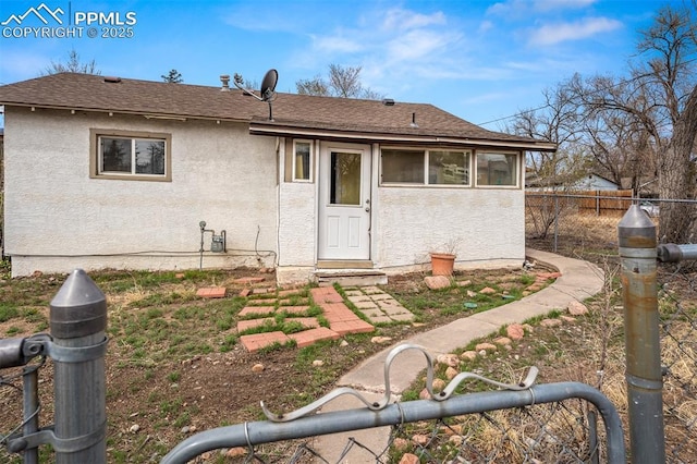224 W Mill St, Colorado Springs, CO 80903 - back of house featuring roof with shingles, stucco siding, and fence