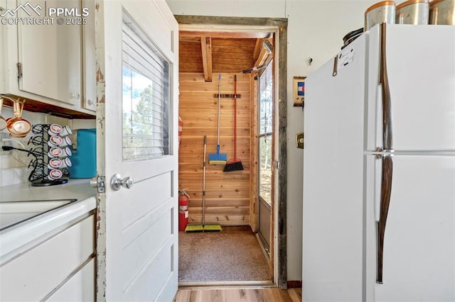 interior space with light wood-style flooring and wooden walls