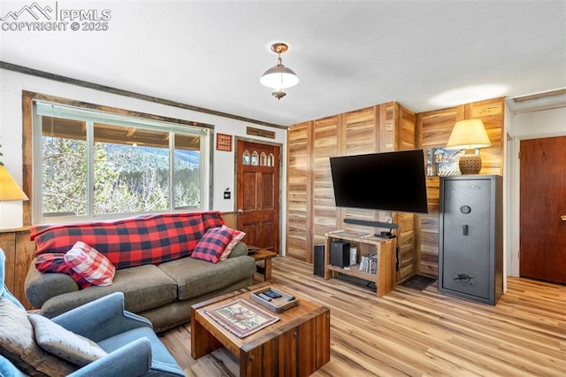 living room with log walls and light wood-style flooring
